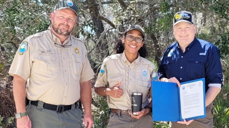 Bryn receiving her employee of the month award from her Park Manager and the District 1 Bureau Chief